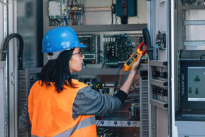 engineer testing voltage with digital multimeter